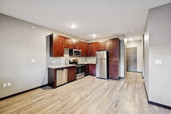 A kitchen with wooden cabinets and a refrigerator.