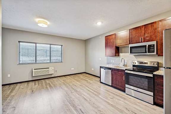 A kitchen with wooden cabinets and stainless steel appliances.