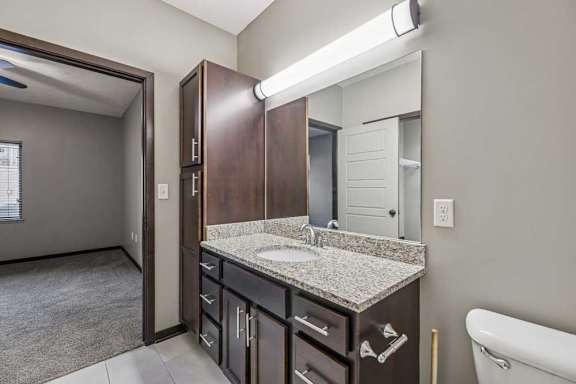A bathroom with a sink, mirror, and a bathtub.