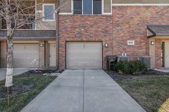 A brick villa style home with a garage door numbered 8650.
