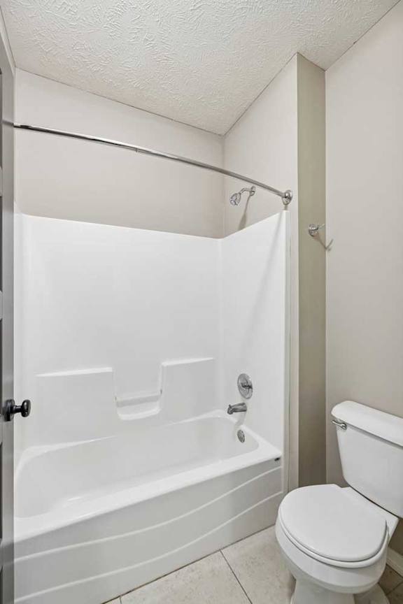 A bathroom with a private lavatory with a tub shower.