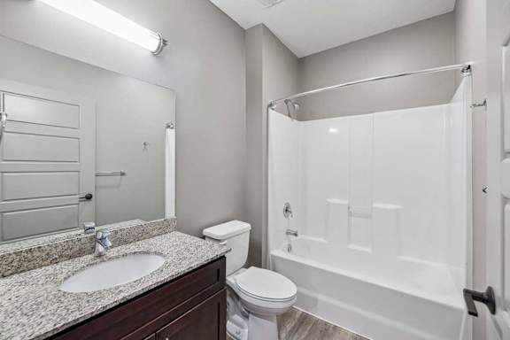 A bathroom with a sink, toilet, and bathtub.