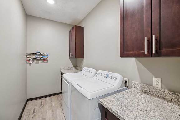 A small laundry room with a washer and dryer.