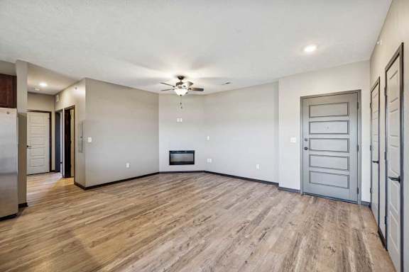 A spacious living room with a fireplace and hardwood floors.