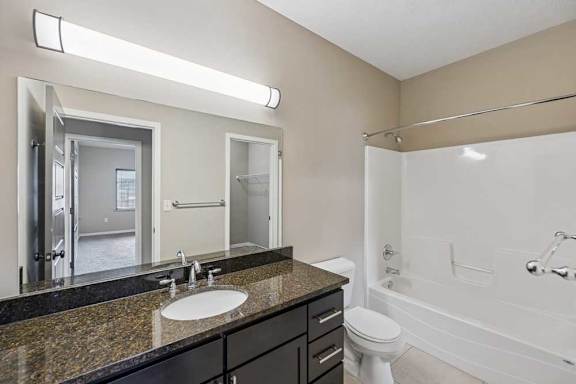 A bathroom with a sink, toilet, and bathtub.