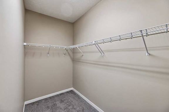 A white closet with a metal rack.