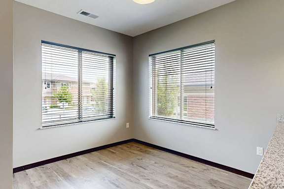 A dining area with two large window for plenty of natural light.