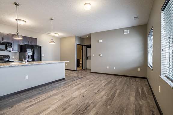 Large open concept floor plan with hardwood-style flooring at North Pointe Villas