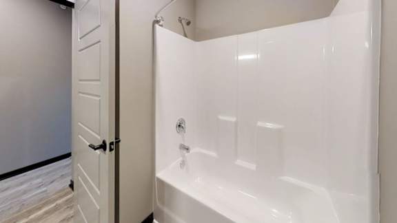 a bathroom with a tub shower