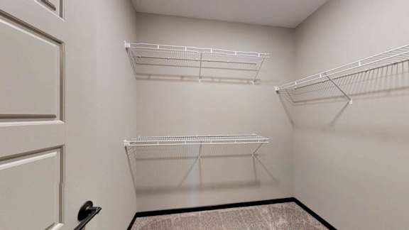 a walk-in closet with built-in shelving and hanging space