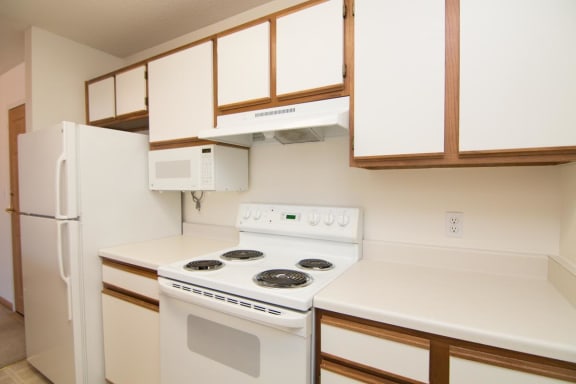 a kitchen with a stove and a refrigerator