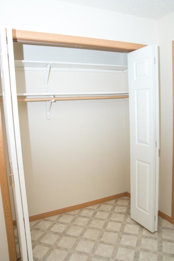 an empty closet in a room with a white door