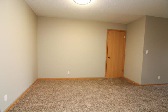 an empty room with a door and a tiled floor