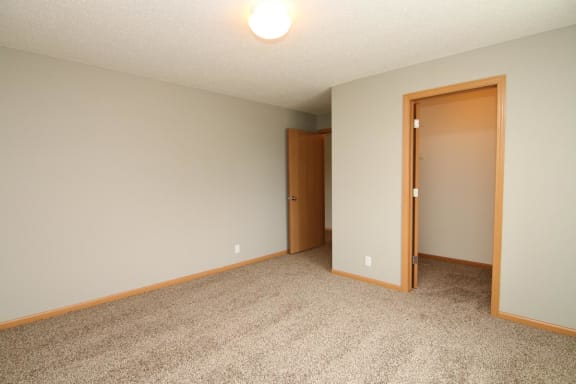 a empty room with a door to a closet