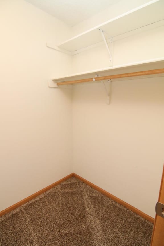 a small room with a white wall and a shelf