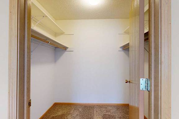 large walk-in closet with storagee walls.