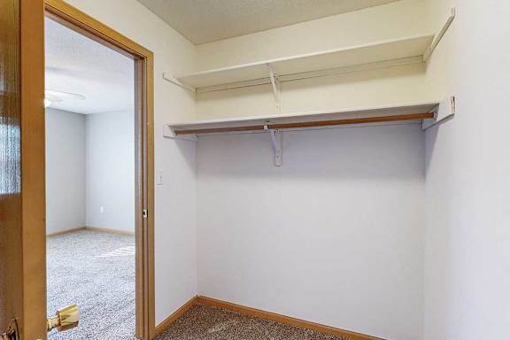 large walk-in closet with a shelving