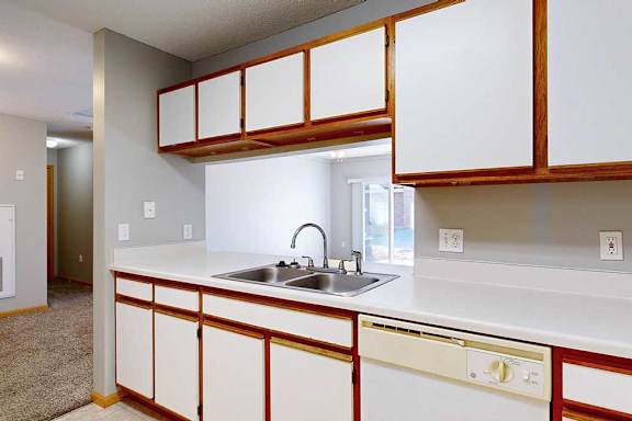 a kitchen with white cabinets and a white counter top
