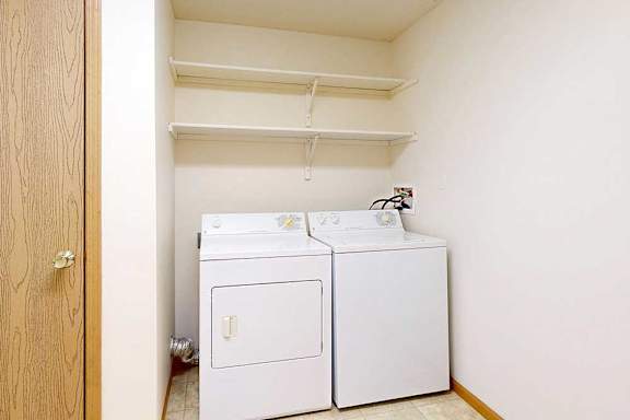 A small laundry room with a washer and dryer.
