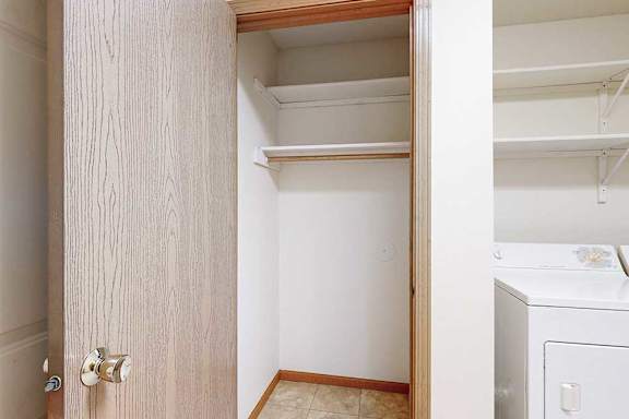 Walk-in storage closet in the laundry area.