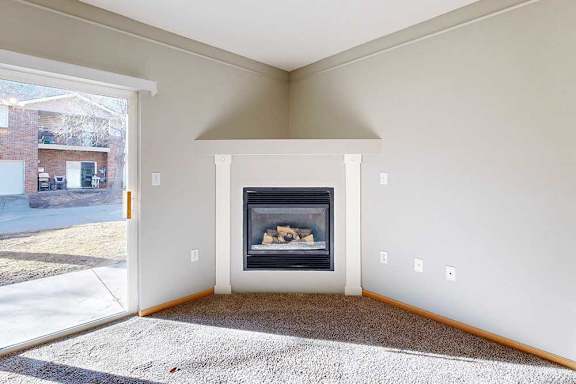 a living room with a fireplace and a sliding glass patio door