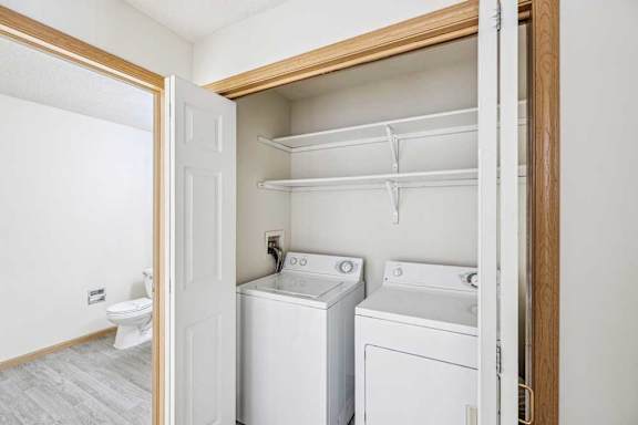 A small laundry room with a washer and dryer.