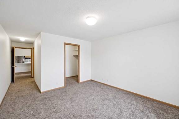 A room with white walls and carpeted floor.