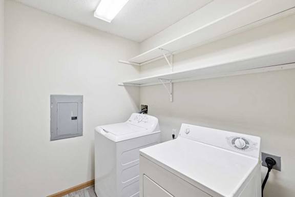 A white washing machine and dryer in a small laundry room.