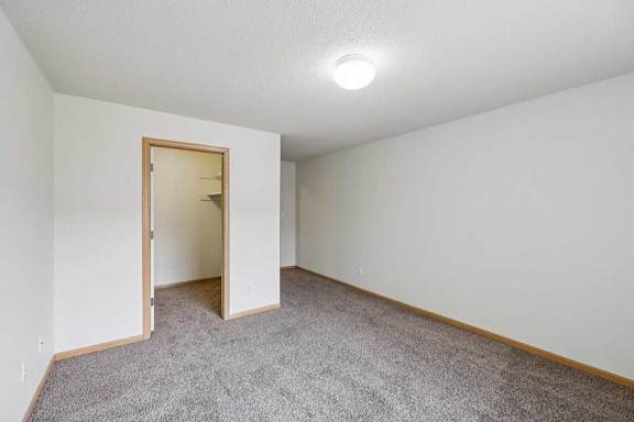 A room with a carpeted floor and a ceiling light.