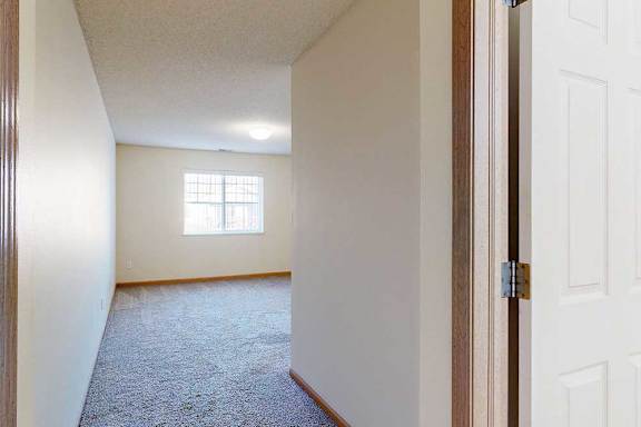 bedroom with a carpeted floor and a window