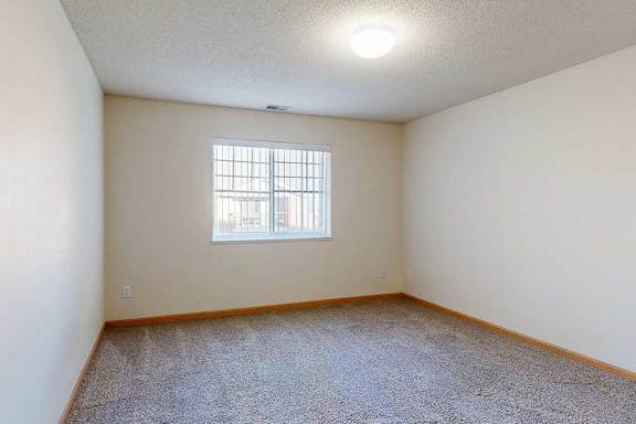 bedroom with a window and a carpeted floor