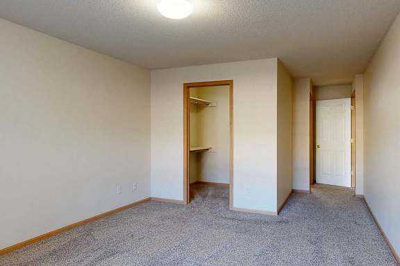 bedroom with a carpeted floor and walk-in closet