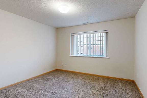 bedroom with a window and carpeted floor