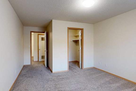 bedroom with carpeted floor and walk in closet