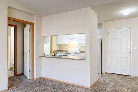 a kitchen area with a breakfast bar with seating