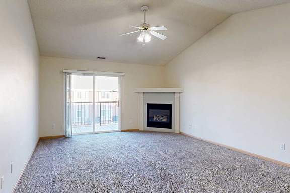 a living room with a fireplace and sliding glass doors