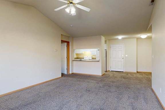 living room with a ceiling fan and carpeted floor