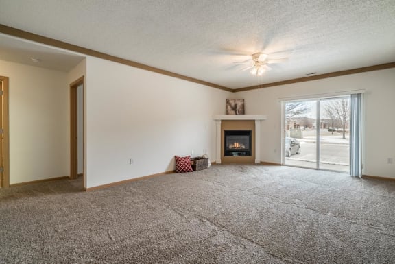 a living room with a fireplace and a door to a patio