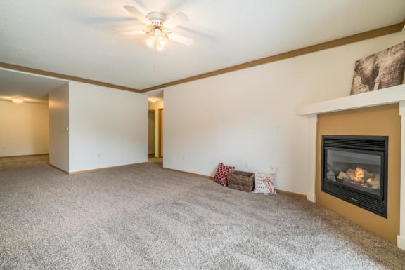 a living room with a fireplace and a carpeted floor