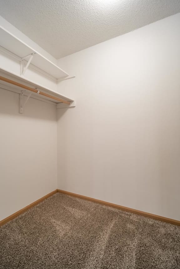 a room with a carpeted floor and a white wall