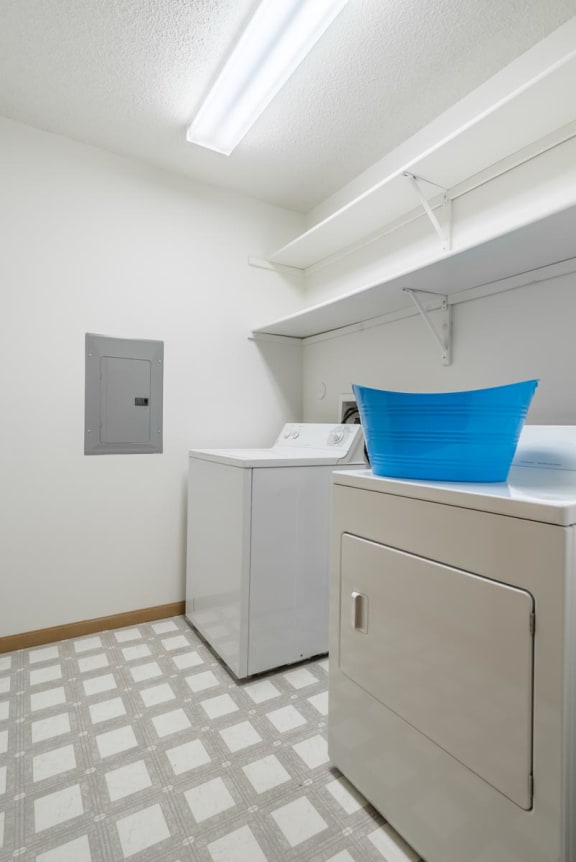 a laundry room with two washes and a dryer