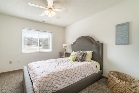 Bedroom with ceiling fan and natural light at Northridge Heights in north Lincoln