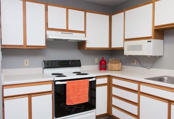 a kitchen with a stove top oven and a sink