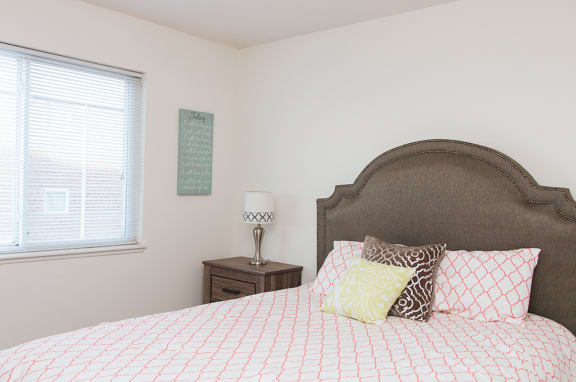 a bedroom with a large bed and a window