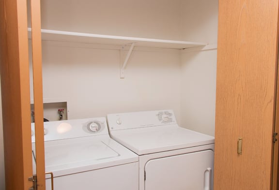 an empty laundry room with a washer and dryer