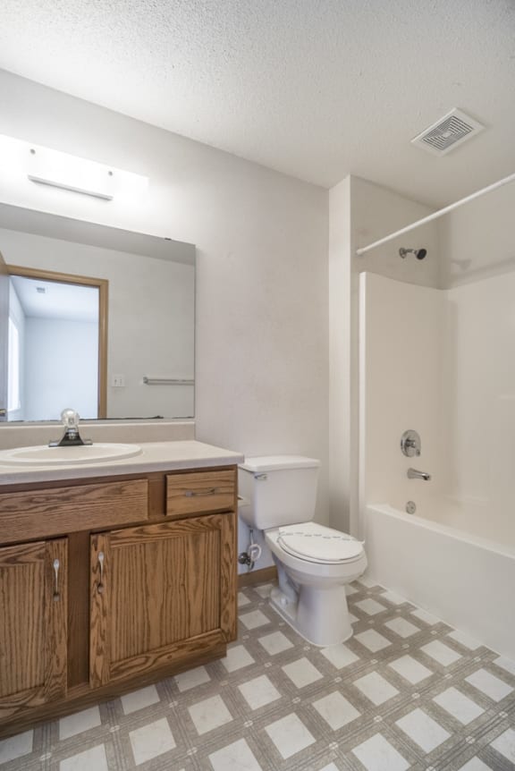 an empty bathroom with a toilet and a sink