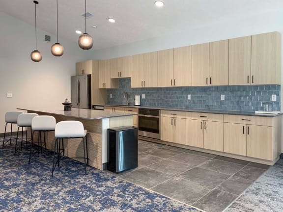 a kitchen with a long counter with bar seating