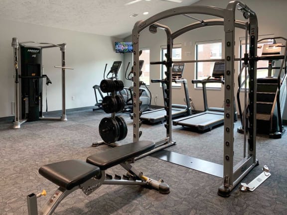 a gym with weights and other exercise equipment in a room