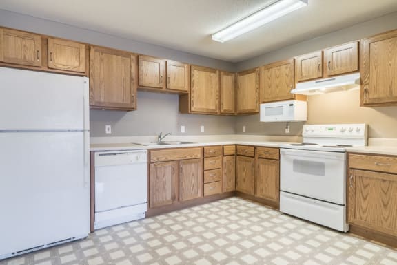 Kitchen with white appliances and lots of cabinet storage at Northridge Heights in north Lincoln