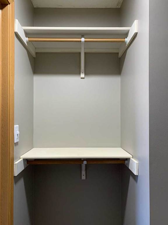 a walk-in closet with built-in shelving and hanging space